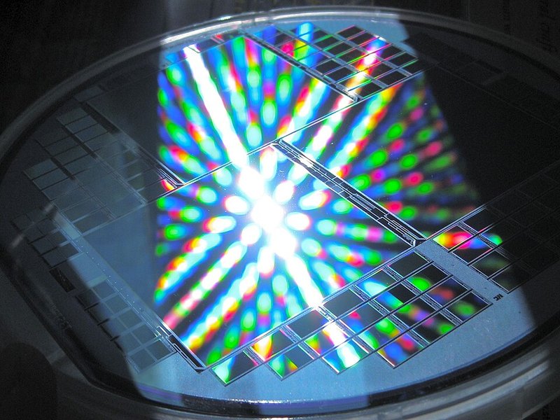 A semiconductor wafer diffracting light into a vivid rainbow spectrum — the nanoscale periodic structures etched into wafers like these are what make 2D materials so promising for next-generation electronics. Credit: Wikimedia Commons