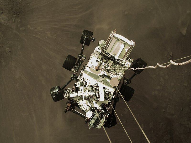 NASA's Perseverance rover captured by the Sky Crane descent stage camera moments before touchdown in Jezero Crater, February 2021 — the first image of a Mars landing in progress. Credit: NASA/JPL-Caltech