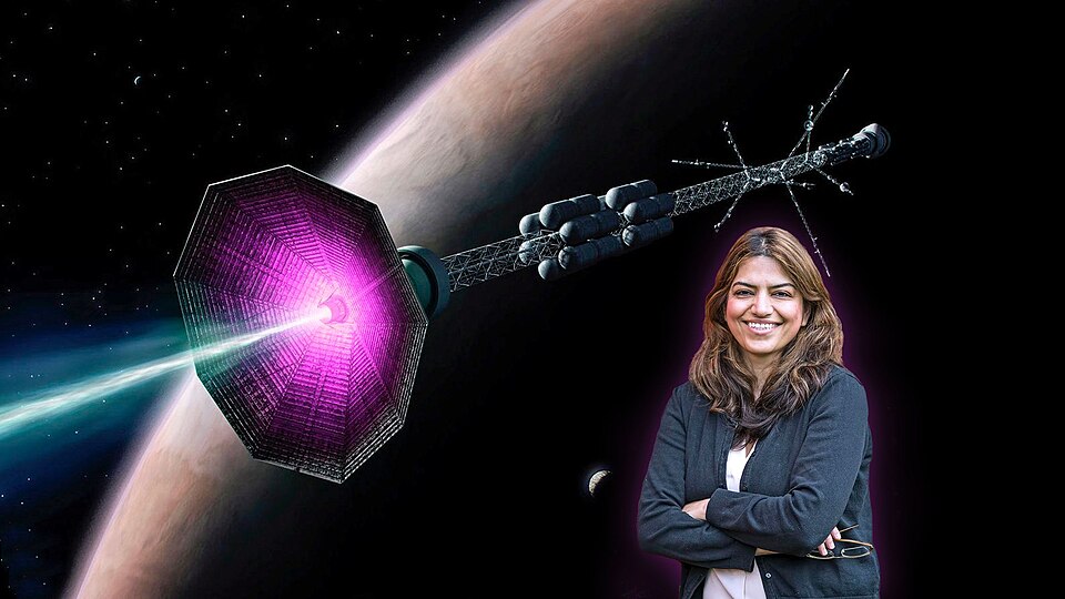Princeton Plasma Physics Laboratory physicist Dr. Fatima Ebrahimi with an artist's concept of a fusion rocket designed for interstellar travel. The revolutionary propulsion system combines magnetic plasma confinement with direct thrust generation, potentially enabling spacecraft velocities approaching 10% light speed. Credit: PPPL/Elle Starkman
